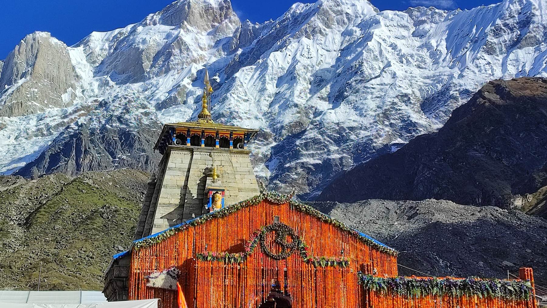Kedarnath Temple decorated with marigolds, below the Himalayan peaks